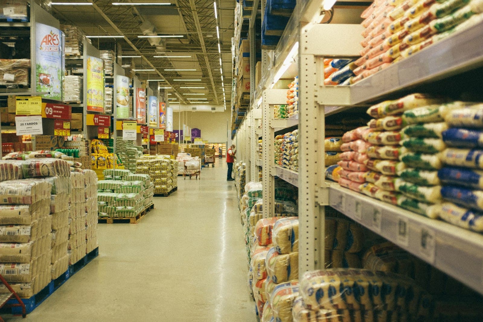 Warehouse aisle with shelving stacked with packaged food products